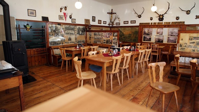 Old school snack station, © Wein Franz Interior view of a rustic restaurant with wooden furniture and wall decorations.