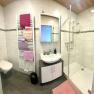 Modern bathroom with a shower, toilet, and sink.