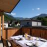 A laid table on a terrace with mountain views.