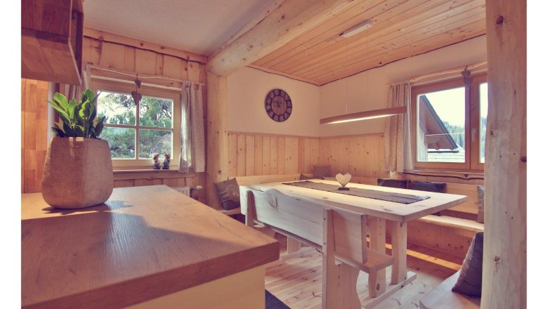 Interior view of a cozy chalet with wooden furniture and decoration.