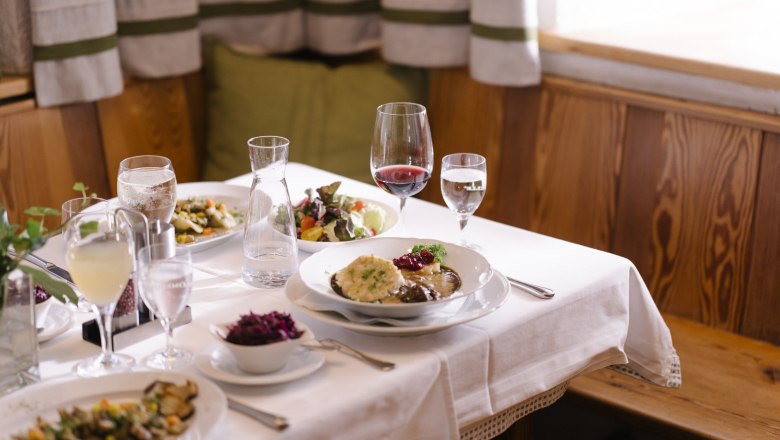 A set table with various dishes and drinks in a cozy restaurant.
