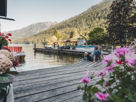 Couple relaxing on the jetty of Lake Lunz