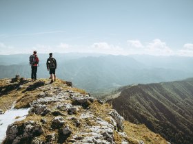 Two hikers stand at the summit and enjoy the breathtaking view over the Ybbstal Alps. The fresh mountain air and majestic landscapes invite you to unwind and experience the beauty of nature.
