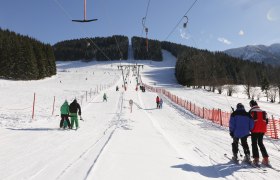 Skiers on a drag lift in the Maiszinken ski area.