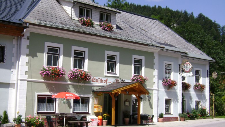 Traditional inn with flower boxes and emperor's beer sign.