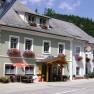 Traditional inn with flower boxes and emperor's beer sign.