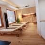 Relaxation area with loungers and wooden paneling at Hotel Fahrnberger.