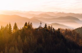 The gentle hills of the Mostviertel glow in the warm light of autumn, while the trees shine in vibrant colors. A cross on the summit invites hikers to enjoy the breathtaking view of the surrounding mountains and valleys. Here, where nature is in full bloom, every visitor finds a place of peace and inspiration.