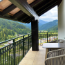 Balcony with a table and chairs, overlooking Lunz am See.